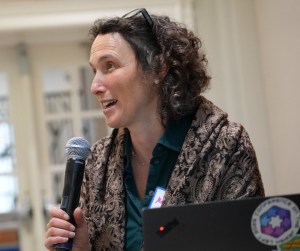 a person with a laptop holding a microphone